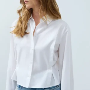 Blusa de popelina con cintura ajustable y mangas largas. YAYA